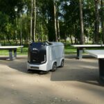 an electric vehicle parked in front of a picnic table