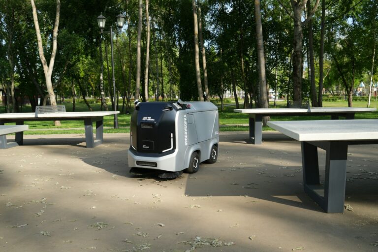 an electric vehicle parked in front of a picnic table